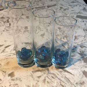 Three glass cylinders with blue stones